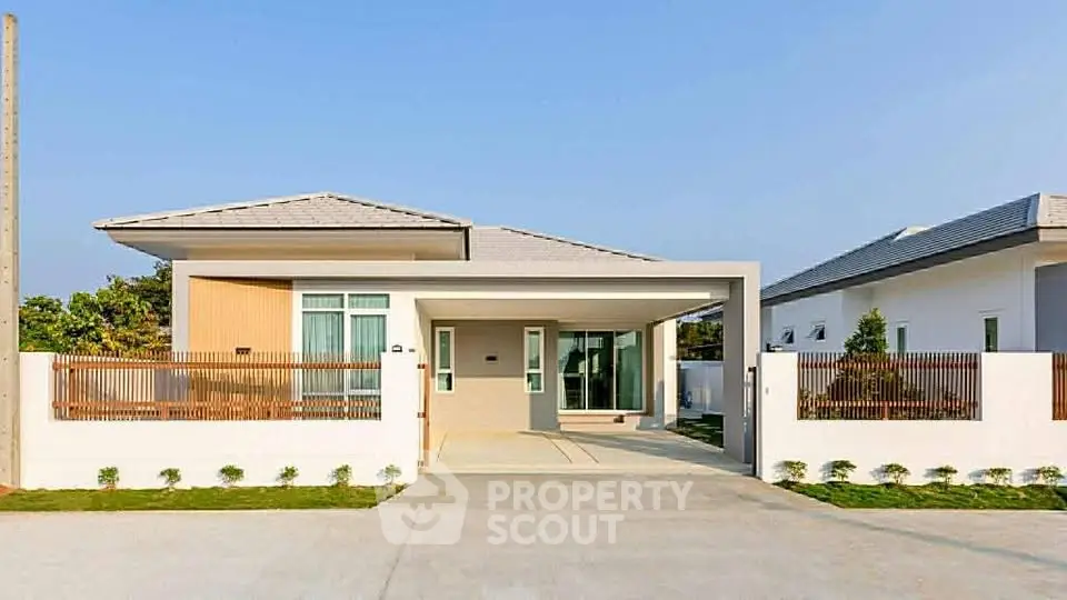 Modern single-story house with sleek design and spacious driveway