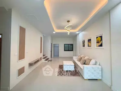 Modern living room with stylish ceiling lights and cozy sofa in a contemporary home.