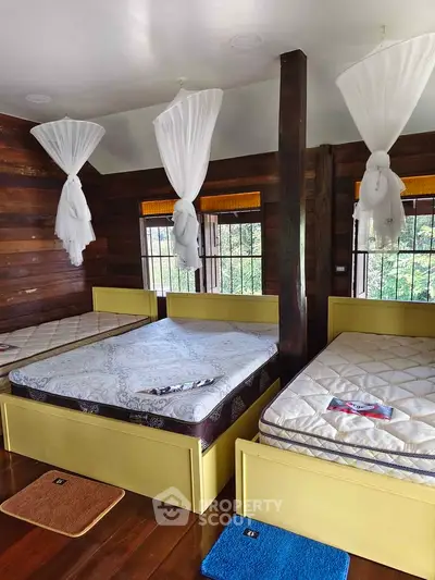 Charming rustic bedroom with wooden walls and cozy twin beds, perfect for a serene retreat.