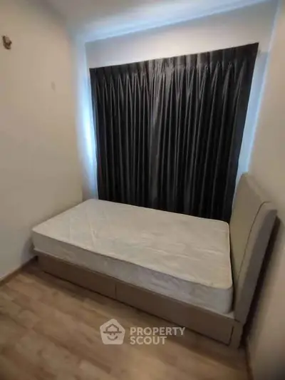 Cozy bedroom with modern bed and elegant curtains, perfect for restful nights.