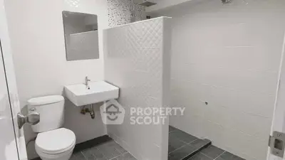 Modern bathroom with sleek white tiles and minimalist fixtures
