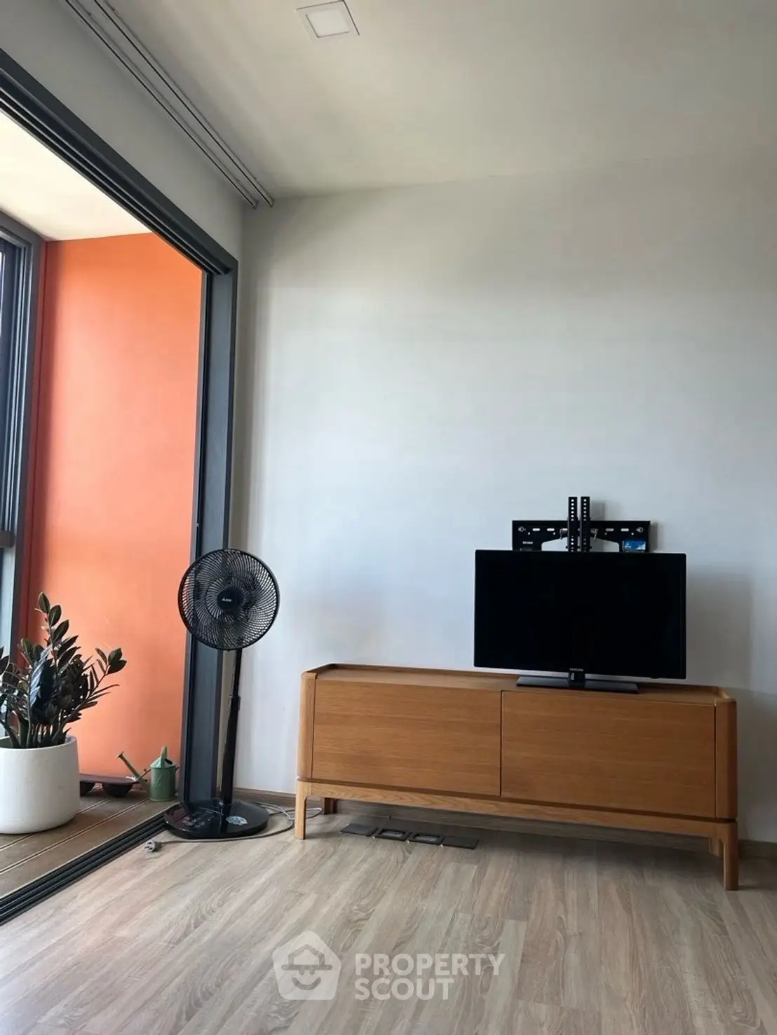 Modern living room with sleek TV stand and balcony view