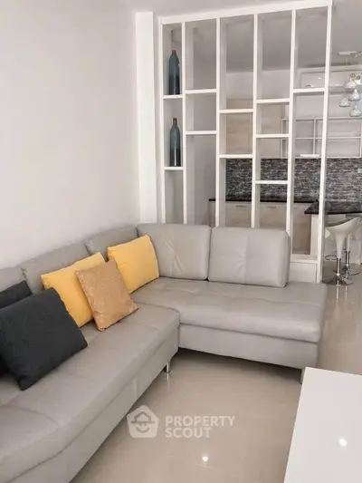Modern living room with stylish sectional sofa and open kitchen layout