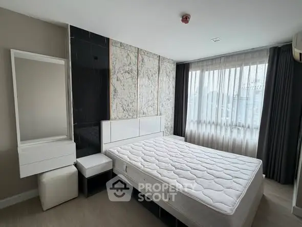 Modern bedroom with large window and stylish marble accent wall