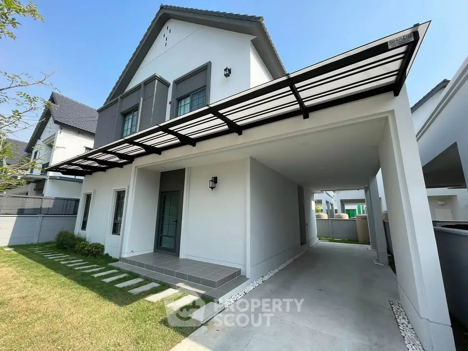 Modern two-story house with sleek design and spacious carport in a serene neighborhood.