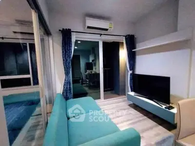 Modern living room with teal sofa and wall-mounted TV, featuring sleek design and cozy ambiance.