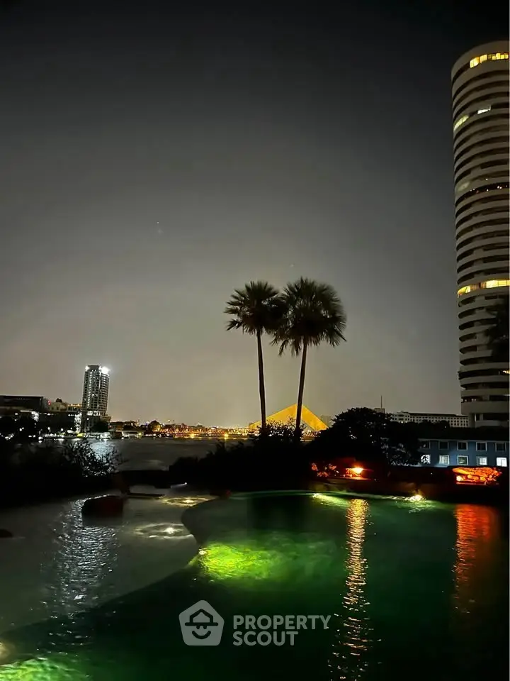 Stunning night view of illuminated pool with city skyline and palm trees, perfect for luxury living.