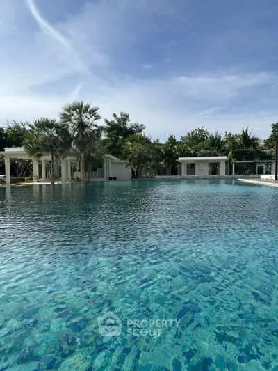 Luxurious poolside view with modern architecture and lush greenery