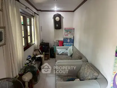 Cozy living room with vintage wall clock and comfortable seating