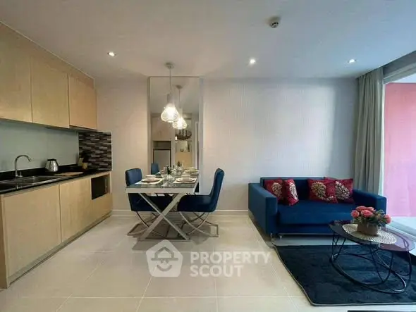 Modern open-plan living room with sleek kitchen and stylish dining area.