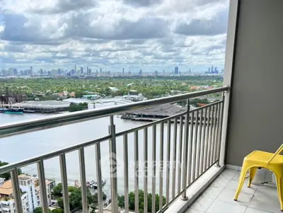 Stunning balcony view overlooking river and city skyline, perfect for relaxation and enjoying urban landscapes.