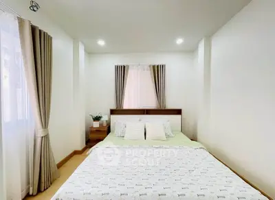 Cozy bedroom with natural light and modern decor, perfect for relaxation.