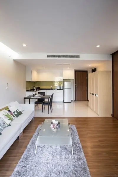 Modern open-plan living room with sleek kitchen and stylish decor