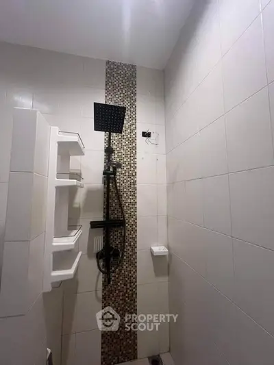 Modern bathroom with sleek showerhead and stylish tile accent wall