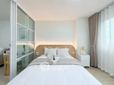 Modern bedroom with cozy decor and natural light, featuring a stylish bed and elegant curtains.