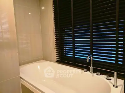 Luxurious bathroom with modern bathtub and sleek blinds