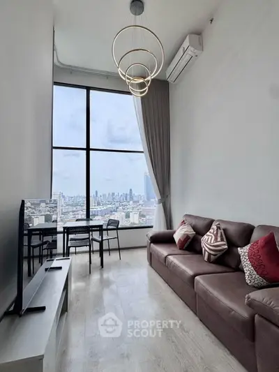 Modern living room with city view, featuring stylish furniture and large windows.