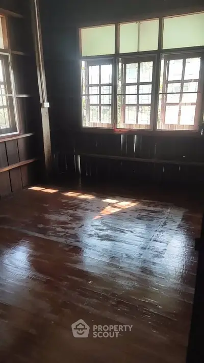 Charming wooden interior with polished floors and large windows