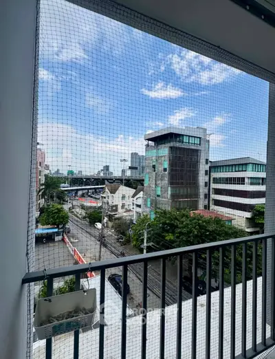 Urban balcony view with cityscape and blue sky, perfect for modern living.