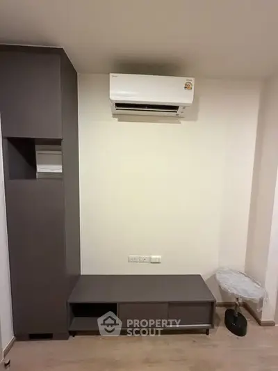 Modern interior with sleek storage unit and air conditioning, perfect for comfortable living.