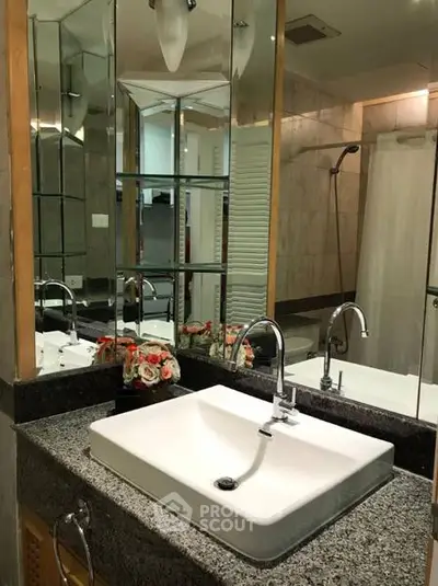 Elegant bathroom with modern sink and mirrored cabinets in luxury home.