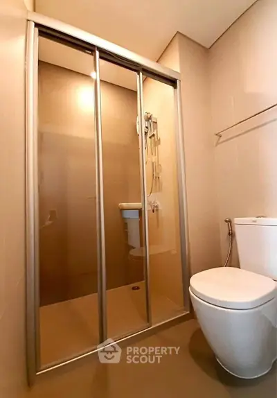 Modern bathroom with sleek shower enclosure and contemporary fixtures.