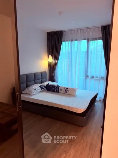 Cozy bedroom with modern decor and large window for natural light