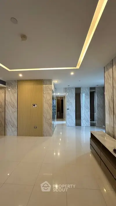 Luxurious modern living room with marble walls and recessed lighting