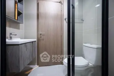 Modern bathroom with sleek fixtures and glass shower enclosure