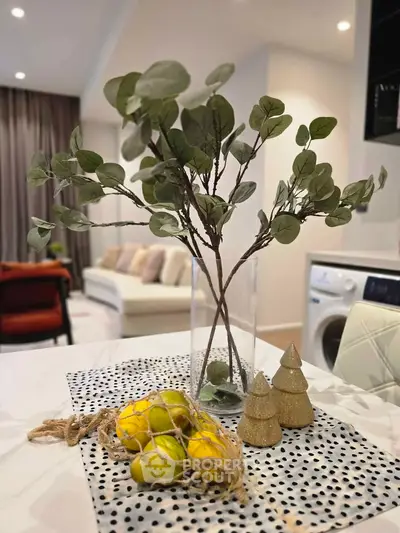 Stylish modern living room with elegant decor and washing machine in view.