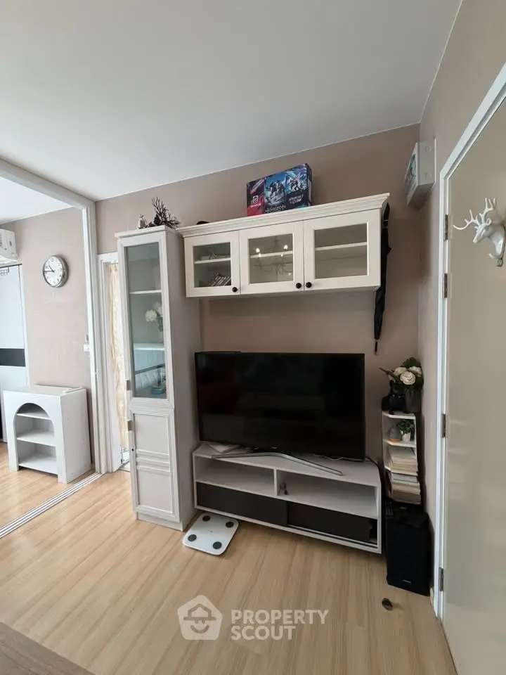 Modern living room with stylish TV unit and wooden flooring