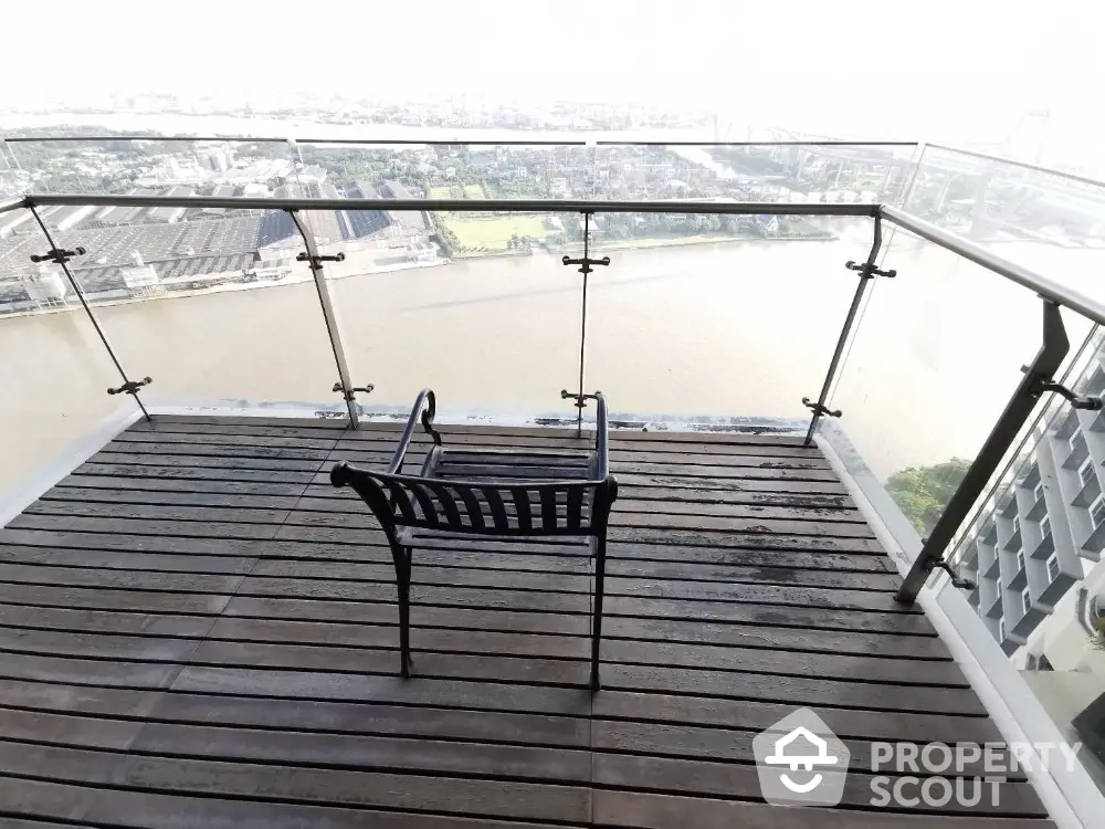 Stunning balcony with panoramic river view and modern glass railing.