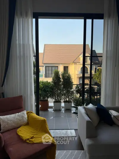 Charming living room with balcony view and cozy seating area.