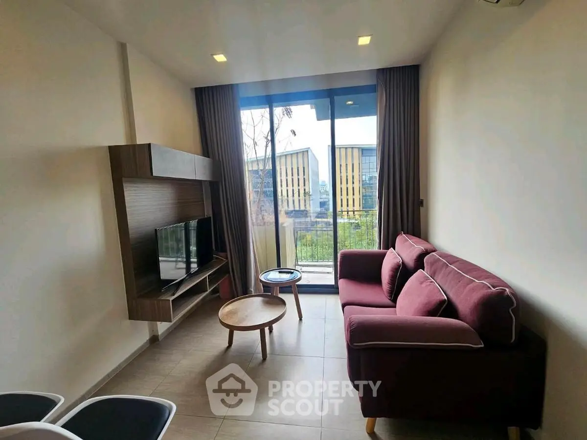 Modern living room with stylish furniture and large window view