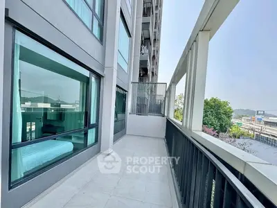 Spacious balcony with modern railing and scenic view in urban apartment
