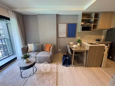 Modern open-plan living room with cozy seating and stylish kitchen area