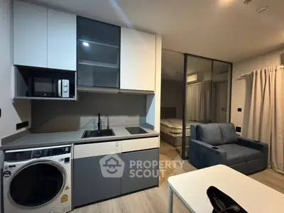 Modern compact kitchen with washing machine and cozy living area