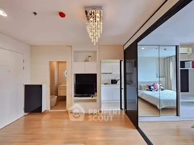Modern studio apartment with open layout and elegant chandelier