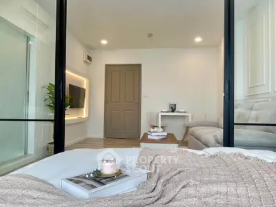 Modern living room with cozy decor and stylish furniture, featuring a sleek TV setup and inviting ambiance.