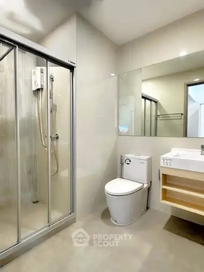 Modern bathroom with glass shower and sleek fixtures