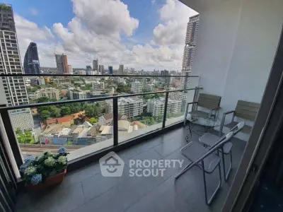 Stunning high-rise balcony with panoramic city views and modern outdoor seating.
