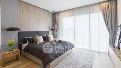 Luxurious modern bedroom with elegant decor and large windows for natural light.