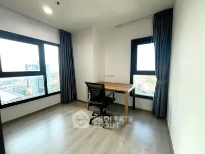 Modern study room with large windows and city view, featuring sleek desk and ergonomic chair.