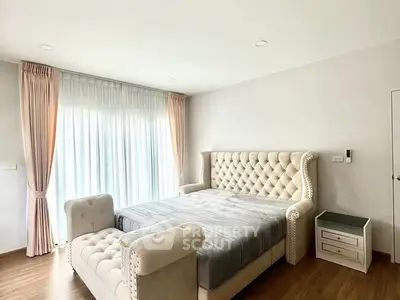 Luxurious bedroom with elegant tufted bed and natural light