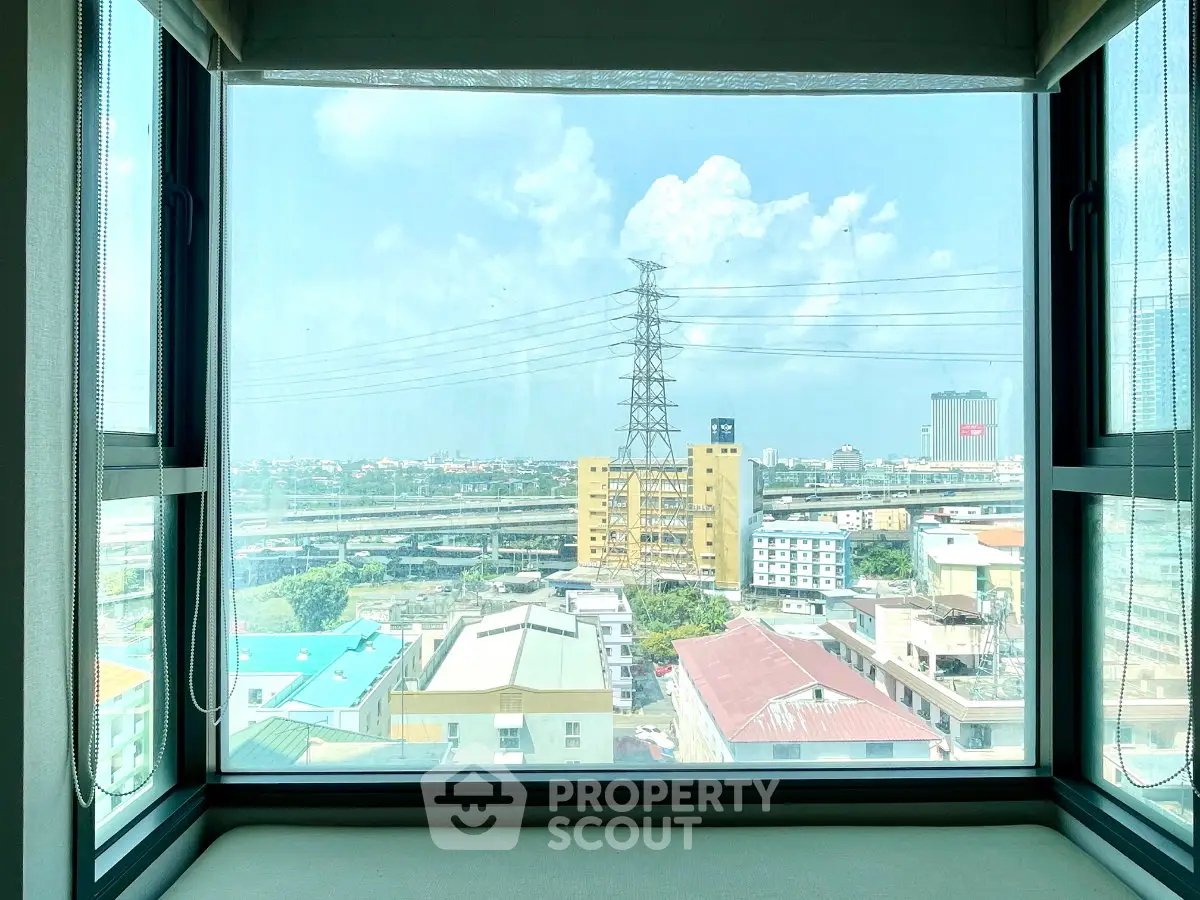 Stunning cityscape view from a modern apartment window, showcasing urban living with expansive skyline.
