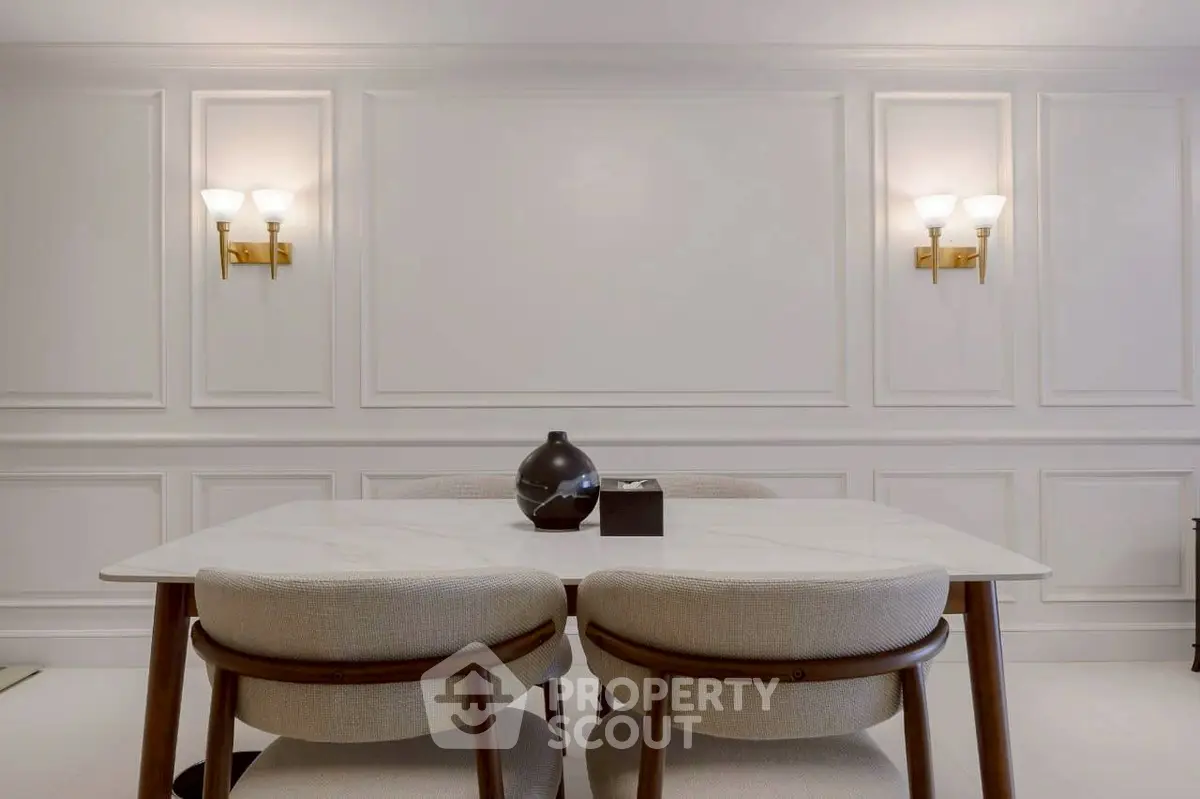 Elegant dining area with modern chairs and stylish wall sconces