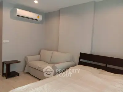 Cozy bedroom with air conditioning and modern furnishings in a stylish apartment.
