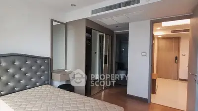 Modern bedroom with stylish headboard and mirrored closet doors