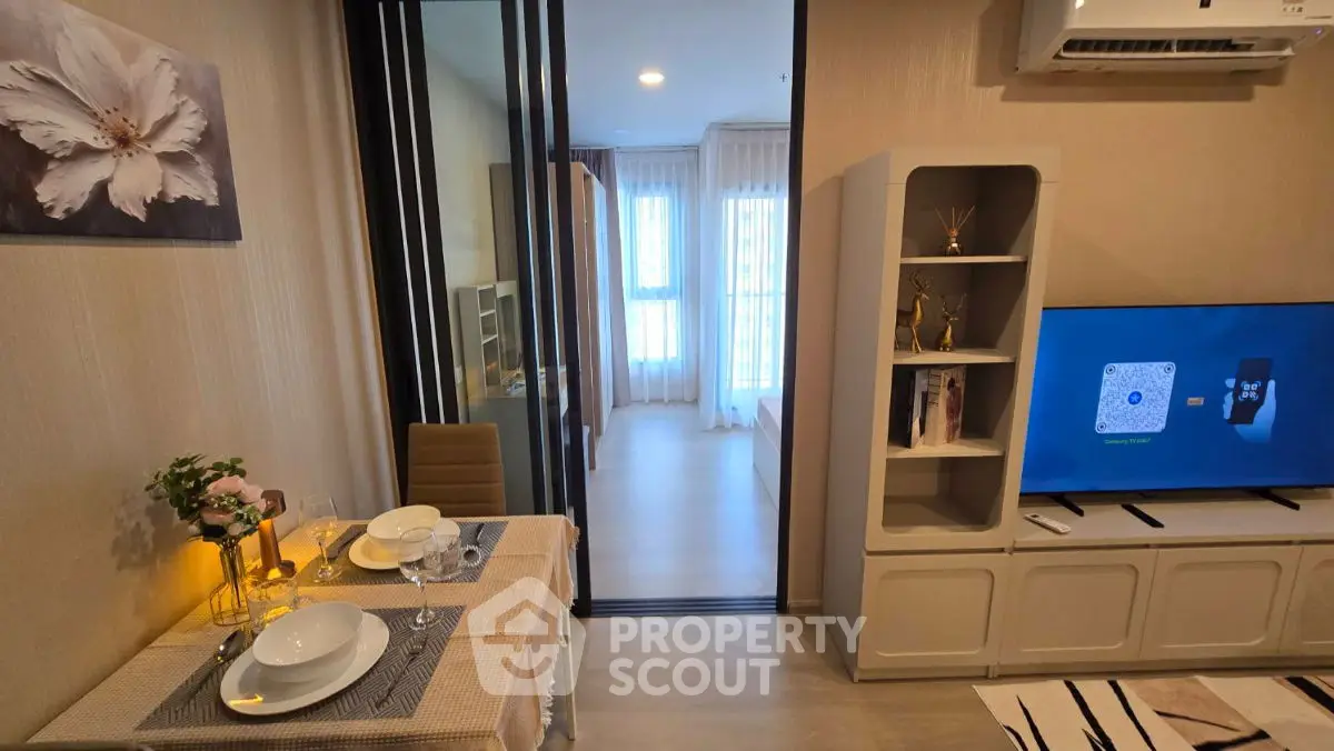 Modern living room with dining area and stylish decor in a cozy apartment.