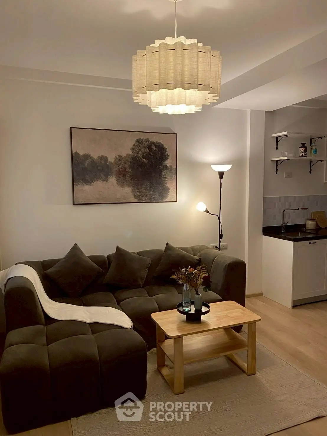 Cozy living room with modern decor and open kitchen layout